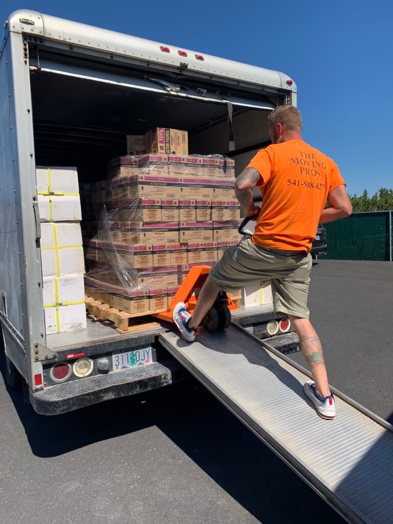 Moving professional unloading palletized boxes from a box truck using a pallet jack