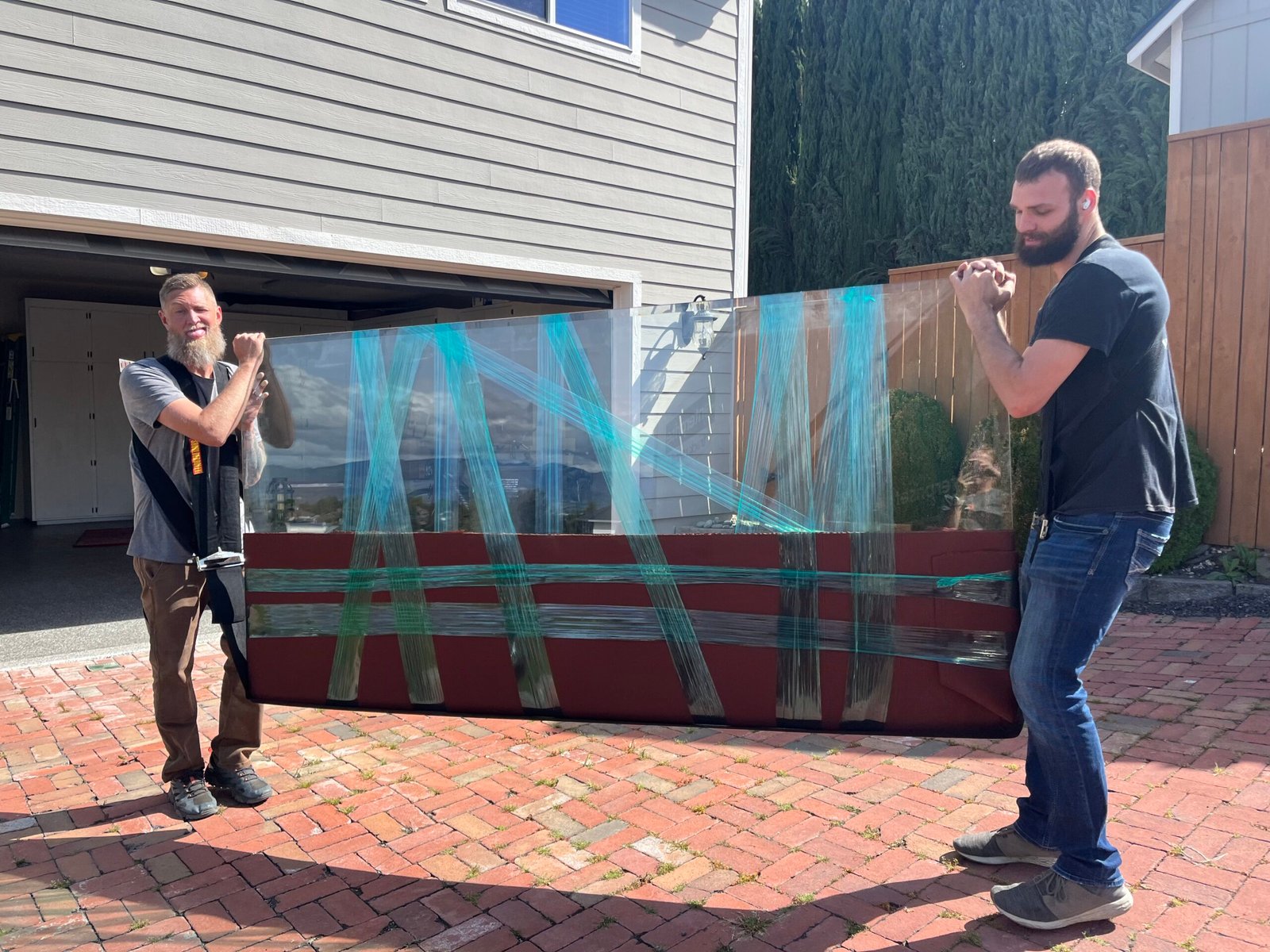 The Moving Pros crew carefully carrying wrapped furniture